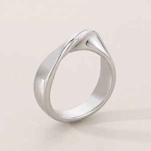 Detailed view of irregular twisted stainless steel ring with a polished silver finish