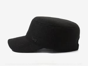 Side view of black flat top winter cap featuring a metal sports style logo and warm fabric
