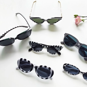 Trendy black and white cat-eye sunglasses collection with various stripe and checkered patterns