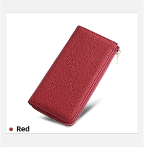 Detail of red pebbled leather long wallet with a secure metal zipper closure