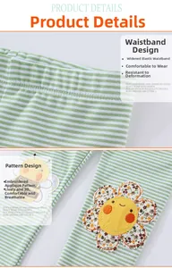 Detail of wide elastic waistband and sunflower appliqué on striped girls' cotton leggings