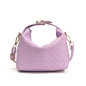 Elegant purple woven texture handbag with gold hardware and shoulder strap on white background