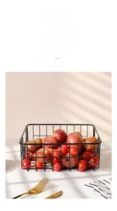 Detail of black rectangular iron fruit basket with minimal mesh design and fresh fruits