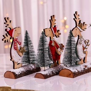 Three-piece wooden Christmas reindeer figurines with mini cedar trees on snowy bases