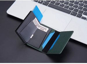 Detail of green leather RFID card holder with pop-up mechanism and cash storage