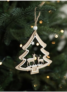 Close-up of wooden Christmas tree ornament with reindeer and star hanging on a branch