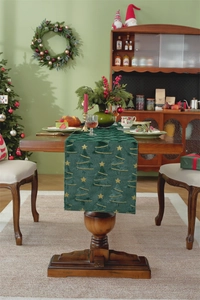 Detail of green velvet Christmas table runner with golden embroidered trees and stars