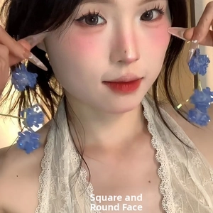 Detailed view of blue floral resin drop earrings featuring multiple stacked flowers