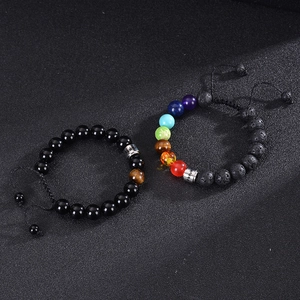 Adjustable stainless steel bracelet set with volcanic stones and chakra beads on dark surface