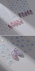 Macro detail of 3D embossed cherry blossom nail stickers with iridescent floral patterns