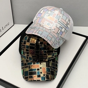 Detail of sequined baseball caps in white and black plaid with breathable mesh