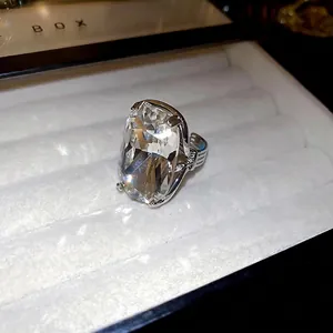 Exquisite cushion-cut cubic zirconia open ring with textured silver band in a jewelry box