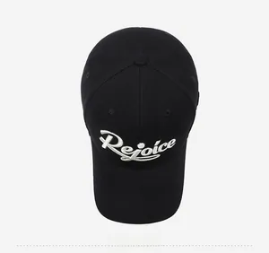 Close-up of white Rejoice 3D embroidery on a black cotton baseball cap fabric