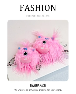 Detailed view of pink furry monster crossbody bags with big eyes and braided straps
