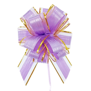 Close-up of a purple pull bow ribbon with gold trim edges for gift wrapping decoration