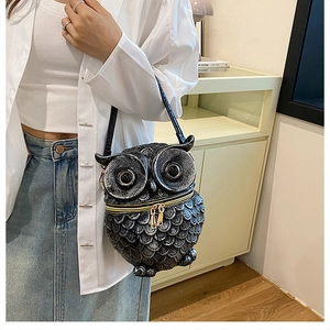Detail of owl-shaped crossbody bag worn by a model in a minimalist indoor setting