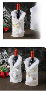 Close-up of plush white Christmas wine bottle cover with metallic snowflake and pom-poms
