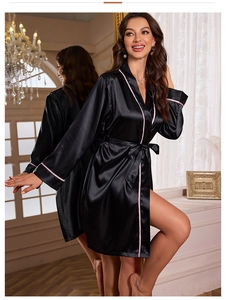 Detail of black satin robe with pink contrast piping and waist tie for women