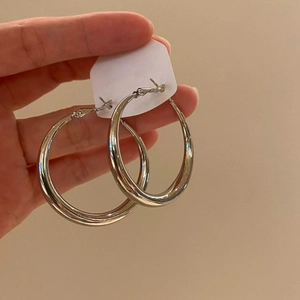 Minimalist large silver round hoop earrings for women with polished metal finish