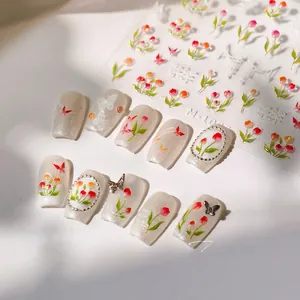 Detailed view of M-1025 tulip and butterfly nail art stickers with glossy pearl accents