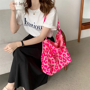 Detail of pink leopard print tote bag showing large capacity and soft fabric texture