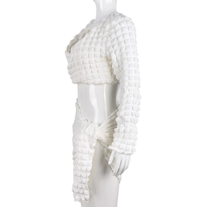 Detail of white popcorn textured long sleeve crop top and wrap skirt two-piece set