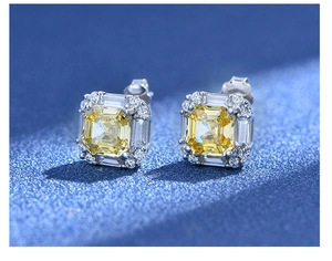 Macro shot of 925 silver stud earrings featuring yellow cushion cut carbon diamonds