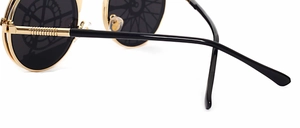 Macro detail of steampunk sunglasses showing metal spring hinges and gear lens patterns