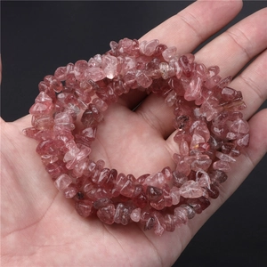 Natural strawberry crystal stone beads held in hand for DIY jewelry making accessories