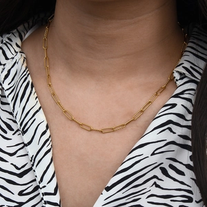 Minimalist gold paperclip necklace with textured chain links worn on collarbone