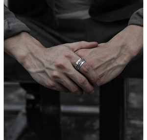 Close-up of men's vintage industrial track ring with weathered silver finish on hand