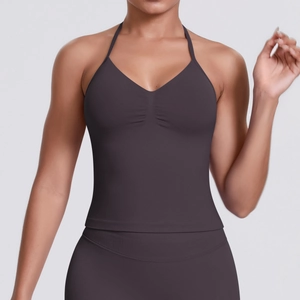 Detail of cross-back straps and pleated V-neck on dark purple high-impact sports bra
