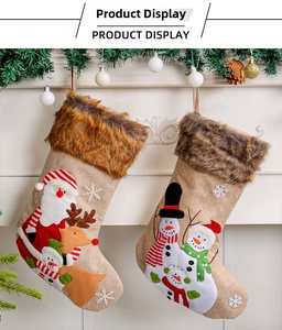 Detail of plush Christmas stockings with 3D Santa and Reindeer embroidery on burlap
