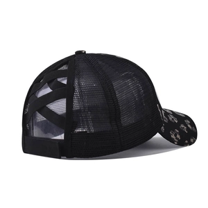 Detail of black mesh baseball cap showing leopard print brim and crisscross ponytail hole