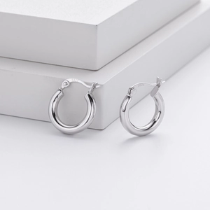 Close-up of S925 sterling silver hoop earrings showing the hallmark stamp and polished finish