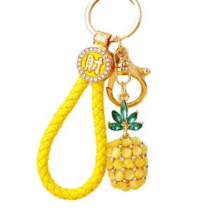 Exquisite gold pineapple keychain with yellow braided rope and lucky charm pendant