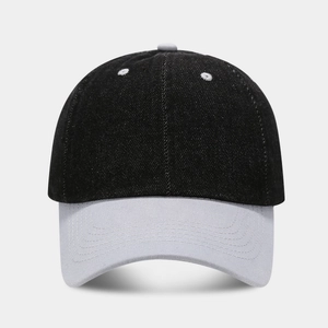 Close-up of black denim baseball cap with grey visor showing detailed stitching