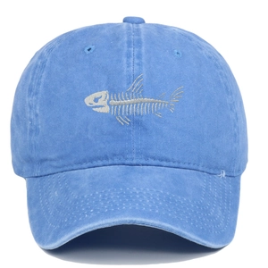 Detail of silver fishbone embroidery on washed blue cotton baseball cap with ventilation