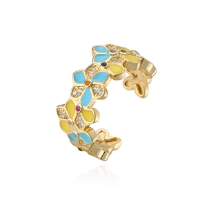 Close-up of gold flower ring with blue enamel petals and colorful zircon stones