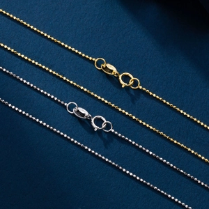 Detailed macro view of S925 sterling silver ball chains in gold and silver finishes