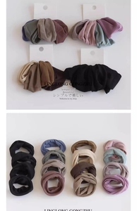Detail of four seamless high-elastic hair ties in neutral Morandi colors on card