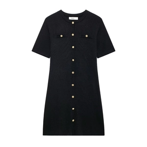 Detail of black short-sleeved knit dress with gold buttons and round neckline