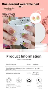 Detail view of French ombre fake nails in yellow and green with decorative crystals