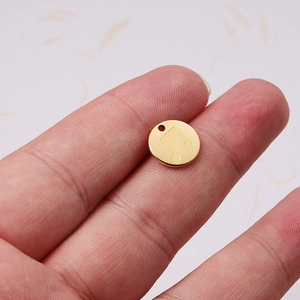 Polished 18K gold plated stainless steel circular pendant with engraved musical note
