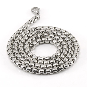 Detailed view of silver stainless steel curb chain with polished metallic texture