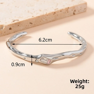 Detail of silver irregular wavy cuff bracelet with inlaid cubic zirconia and dimensions