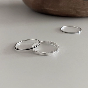 Minimalist 925 sterling silver ring set featuring spiral twisted and smooth black band designs