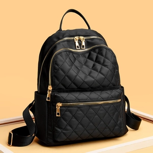 Fashionable black quilted nylon backpack with gold zippers for travel and casual outdoor use