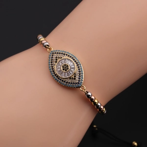 Detailed view of adjustable Evil Eye bracelet with blue zircon and gold beaded chain