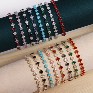 Colorful zircon star bracelets in gold and silver plating displayed on jewelry stands